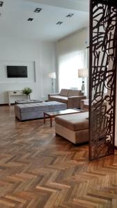 a living room with two couches and a television at Hotel Viña de Italia in Cordoba