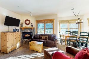 Una sala de estar con un sofá y una chimenea. en Tenderfoot Lodge 2621, en Keystone