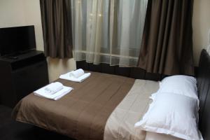 A bed or beds in a room at Guest house VRAZHDEBNA