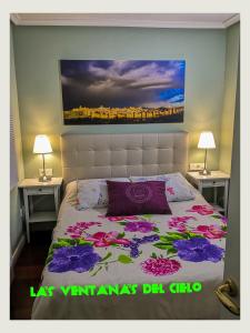 a bedroom with a bed with two night stands and two lamps at Antigua Ventanas del Cielo, BAJA in Ávila