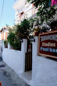 a sign for a pool bar on the side of a building at Taxiarchis Apartments in Skiathos