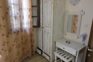 a bathroom with a sink and a mirror at Taxiarchis Apartments in Skiathos +58 photos