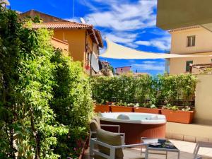 einen Hinterhof mit einem Whirlpool und einer Hecke in der Unterkunft CASA MANDO with Terrace and Jacuzzi in Taormina