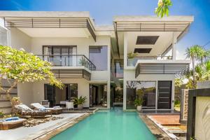 an exterior view of a house with a swimming pool at Villa Cascade in Seminyak