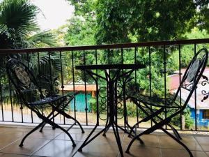 two chairs and a table on a balcony at Hotel Casa Esmeralda in Sámara