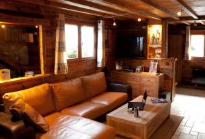 a living room with a couch and a coffee table at Chalet Dreamtime in Les Villards-sur-Thônes