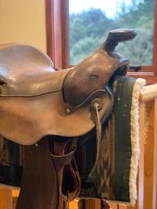 una silla de caballo de madera sobre una mesa con una ventana en Lyford's Boutique Retreat - Relax & Enjoy, en Mt Lyford