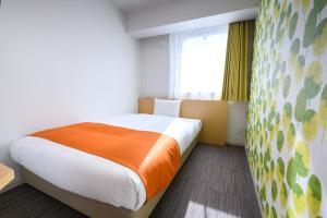 Postel nebo postele na pokoji v ubytování Hotel Sobial Namba Daikokucho