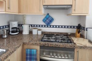 Kuchyň nebo kuchyňský kout v ubytování Apartamentos Lido