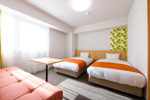 Postel nebo postele na pokoji v ubytování Hotel Sobial Namba Daikokucho