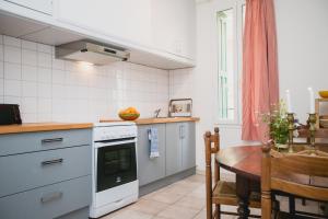 a kitchen with a table and a stove top oven at Regina's Banyuls - Spatious apartment next to the beach in Banyuls-sur-Mer