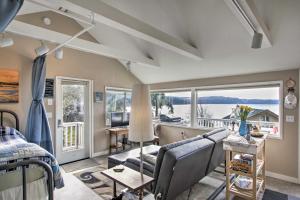 a living room with a view of the water at Idyllic Waterfront Cottage with Beach and Sunset Views! in Port Townsend
