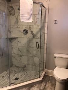 a bathroom with a shower with a toilet at Talbott Tavern and Inn in Bardstown