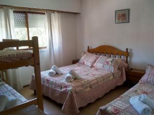 a bedroom with two beds and a bunk bed at Hotel La Terraza in Villa Gesell
