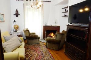 Il comprend un salon avec une cheminée et une télévision. dans l'établissement Casa D'Avó Mila, à Góis