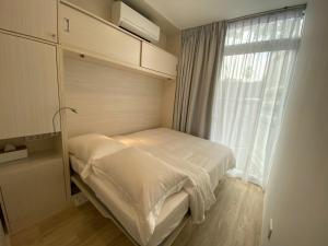 a small bedroom with a bed and a window at Shipping Container Hotel at Haw Par Villa GoogleMap Address 27 Zehnder Road Taxi and cars can only enter via Zehnder Road in Singapore
