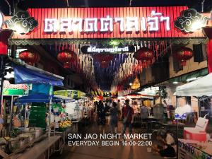 a market with people walking through it at night at Boundary Hostel and Cafe in Surat Thani