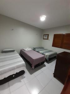 a bedroom with two beds in a room at Casa de Praia Luis Correia in Luis Correia