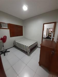 a bedroom with a bed and a mirror and a desk at Casa de Praia Luis Correia in Luis Correia