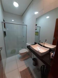 a bathroom with a toilet and a sink and a shower at Casa de Praia Luis Correia in Luis Correia