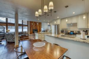 a large kitchen with a wooden table and chairs at Golf & Ski Premier in Vail