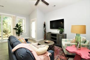 a living room with a couch and a tv at Beacon Quarters by KEES Vacations in Corolla