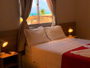 a bedroom with a bed with a view of the beach at Pousada Paraíso Maragogi in Maragogi