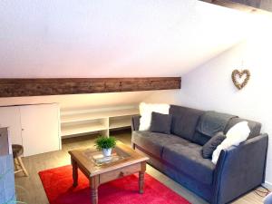 a living room with a couch and a table at Appartement Duplex Forclaz in Chamonix