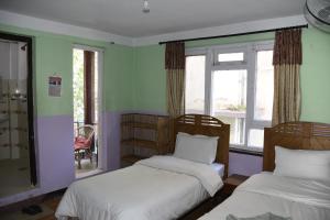 Ένα ή περισσότερα κρεβάτια σε δωμάτιο στο Beehive Hostel Kathmandu