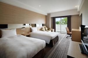 Postel nebo postele na pokoji v ubytování Grand Prince Hotel Shin Takanawa