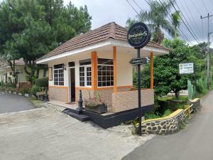 a small building with a sign in front of it at Arra Lembah Pinus Ciloto in Puncak