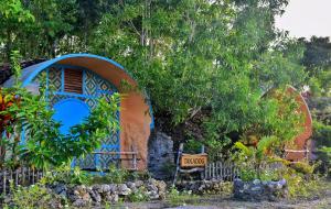 a house that is painted blue and orange at Kamp Aninipot in Siquijor
