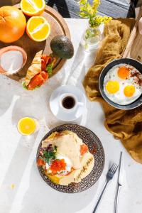 a table topped with plates of eggs and bread at Astoria Hotel in Vladivostok