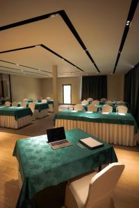 a conference room with a table with a laptop on it at Edelweiss Art Hotel in Ulaanbaatar