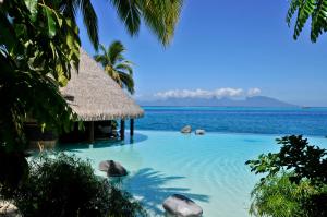 a beach with palm trees and palm trees at InterContinental Tahiti Resort & Spa, an IHG Hotel in Faaa