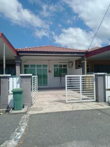 a house with a gate in front of it at Hazz Homestay Alor Setar in Alor Setar