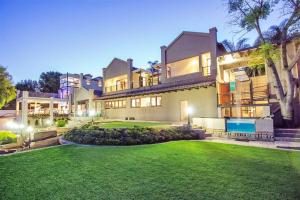 a large house with a lawn in front of it at inn on mars in Pretoria