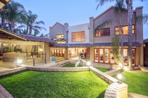 an exterior view of a house with a yard at inn on mars in Pretoria
