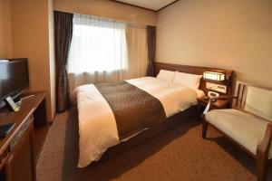 Postel nebo postele na pokoji v ubytování Dormy Inn Premium Otaru