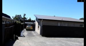 a car parked in a garage next to a building at Westport Central Apartment in Westport