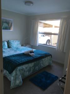 a bedroom with a bed with a stuffed animal on it at Westport Central Apartment in Westport