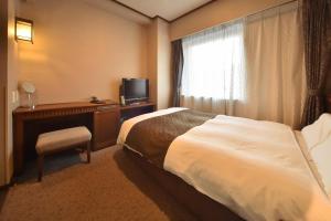 Postel nebo postele na pokoji v ubytování Dormy Inn Premium Otaru