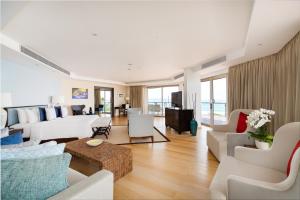 a living room with white couches and a table at Double - Six, Luxury Hotel - Seminyak in Seminyak