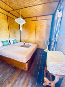 a bedroom with a bed with a sink and a table at Pai Smilehouse in Pai