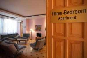 a three bedroom apartment with couches and a waiting room at Apart-Hotel David in Tbilisi City
