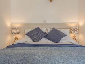 a bed with two pillows on top of it at Potters by the Sea in Penzance