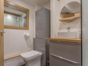 a bathroom with a white toilet and a sink at Potters by the Sea in Penzance