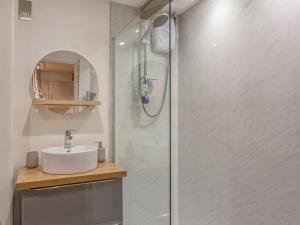 a bathroom with a sink and a shower at Potters by the Sea in Penzance