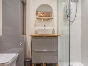 a bathroom with a sink and a shower at Potters by the Sea in Penzance
