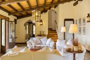 a living room with a white couch and a table at Villa Manavra in Ipsos
